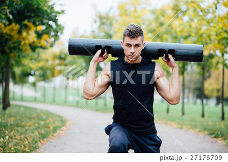Male fitness doing exercise lunge with vipr Male fitness doing exercise lunge with vipr 27176709