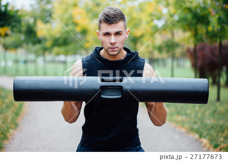 Male fitness doing exercise lunge with vipr Male fitness doing exercise lunge with vipr 27177673