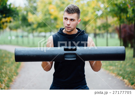 Male fitness doing exercise lunge with vipr Male fitness doing exercise lunge with vipr 27177705