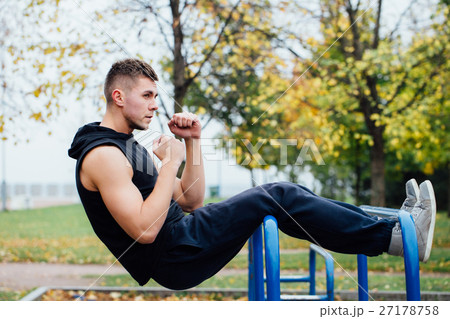 Fitness man doing stomach workouts on horizontal Fitness man doing stomach workouts on horizontal 27178758