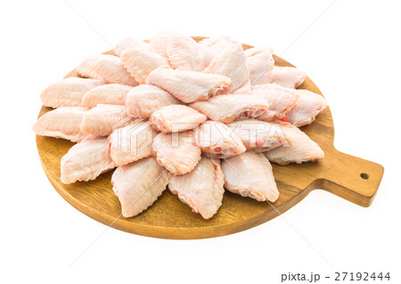 Raw chicken meat and wing on wooden cutting board or plate 27192444