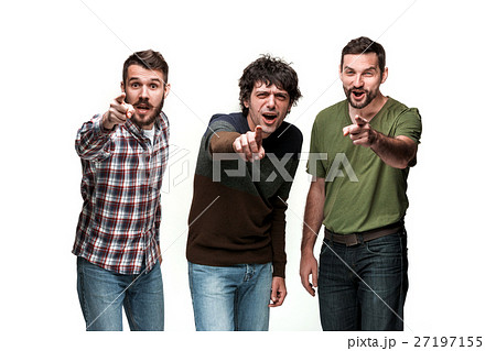 The three men are smiling, looking and pointing at The three men are smiling, looking and pointing at 27197155