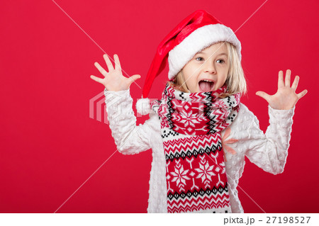 little girl in santa hat on red background little girl in santa hat on red background 27198527