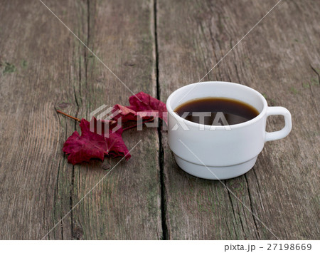 still life, coffee and brightly red leaf on table still life, coffee and brightly red leaf on table 27198669