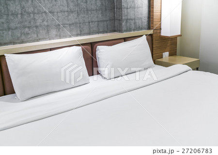 Comfortable pillows and bed . 27206783