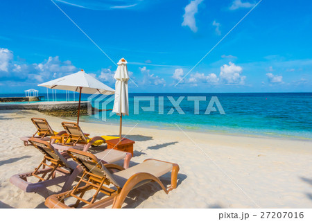 Beach chairs with umbrella at Maldives island with white sandy beach and sea . Beach chairs with umbrella at Maldives island with white sandy beach and sea . 27207016