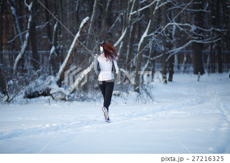 Young woman running among trees Young woman running among trees 27216325