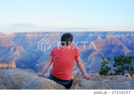 Man sitting on stone and looking of the Grand Canyon 27218237