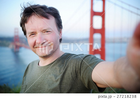 Middle age man making a self portrait with Golden Gate bridge in Middle age man making a self portrait with Golden Gate bridge in 27218238