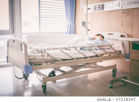 Asian boy lying on sickbed with saline intravenous (IV).  27218347