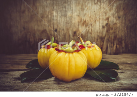 Garcinia cambogia fruit on wood background.  27218477