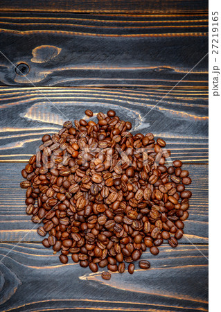roasted coffee beans on wooden background roasted coffee beans on wooden background 27219165