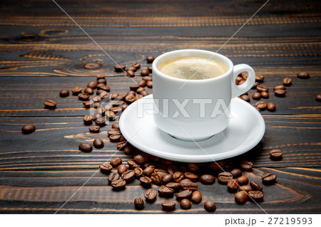 roasted coffee beans and cup on wooden background 27219593