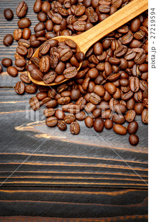 wooden spoon of roasted coffee beans on table wooden spoon of roasted coffee beans on table 27219594
