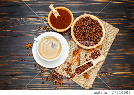 mug with roasted coffee beans on wooden background 27219602