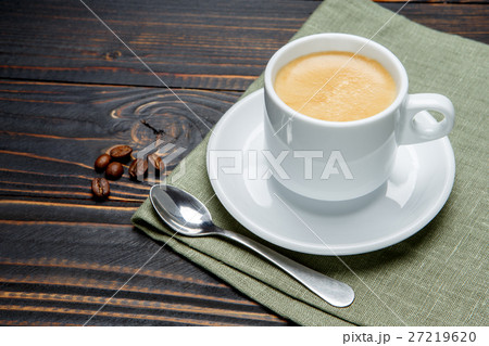 roasted coffee beans and cup on wooden background 27219620