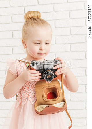 little girl holding a camera 27223135