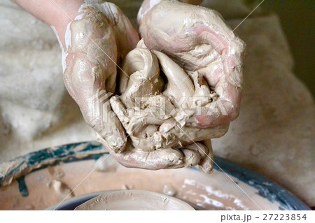 potter holds the clay wet raw close-up potter holds the clay wet raw close-up 27223854