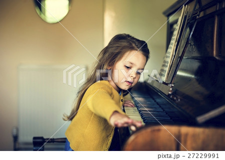 Adorable Cute Girl Playing Piano Concept 27229991