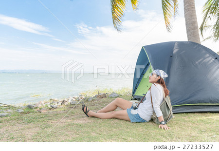 Hipster traveler woman relax with tent on dam location Hipster traveler woman relax with tent on dam location 27233527