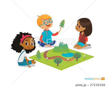 Children sitting on floor explore toy landscape 27236300