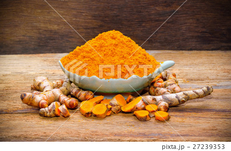 fresh turmeric roots on wooden table 27239353