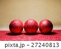 Christmas balls on snow over red background 27240813