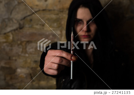 Drug addict posing near brick wall 27241135