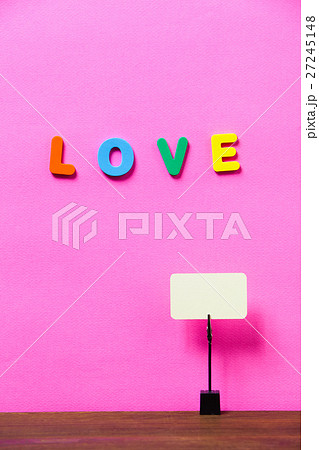 Paperclip hold blank card on a desk with letter LO Paperclip hold blank card on a desk with letter LO 27245148