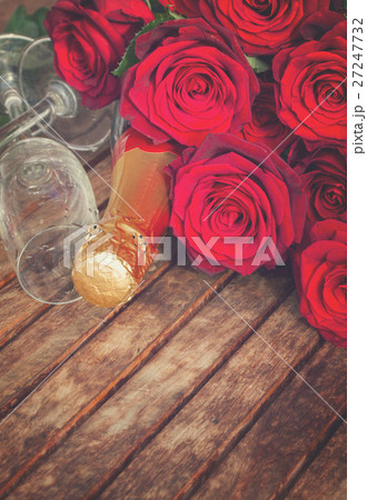 dark red  roses with neck of champagne 27247732