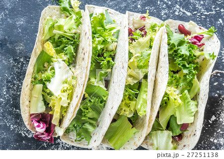 Four vegetarian tacos on a black background Four vegetarian tacos on a black background 27251138