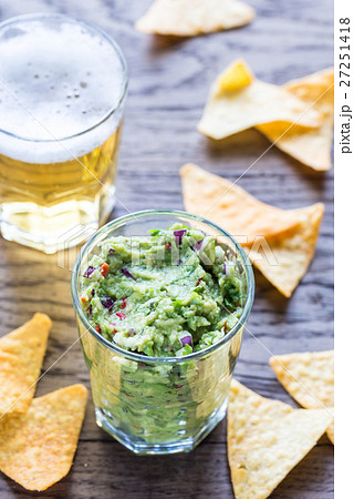 Guacamole with tortilla chips and glass of beer Guacamole with tortilla chips and glass of beer 27251418