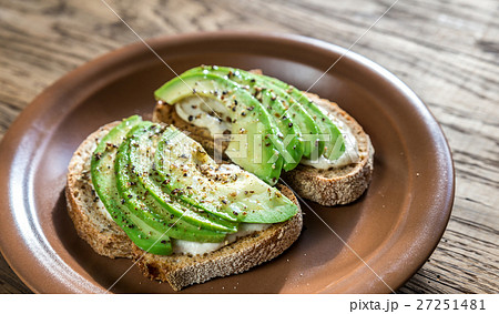 Toasts with tahini sauce and sliced avocado Toasts with tahini sauce and sliced avocado 27251481