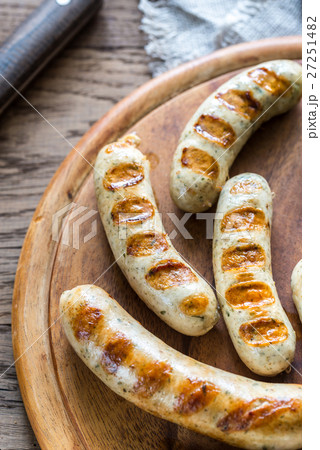 Grilled sausages on the wooden board Grilled sausages on the wooden board 27251482