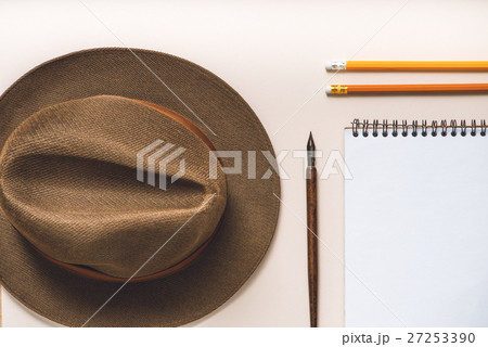 Brown hat near writing materials 27253390
