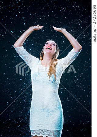 The young girl standing under running water The young girl standing under running water 27255698