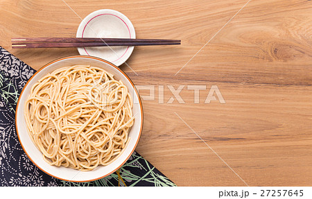 Bowl of noodles with wooden chopsticks on wood Bowl of noodles with wooden chopsticks on wood 27257645
