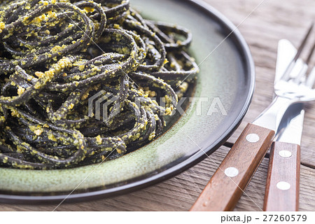 Black pasta with pesto sauce 27260579