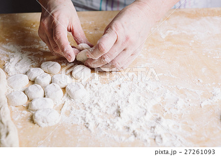 Two hands making dough for meat dumplings. Two hands making dough for meat dumplings. 27261093