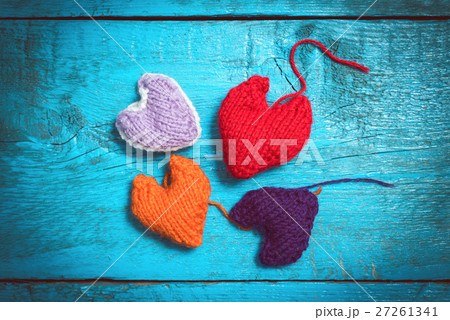 Colorful knitted hearts on the blue boards Colorful knitted hearts on the blue boards 27261341