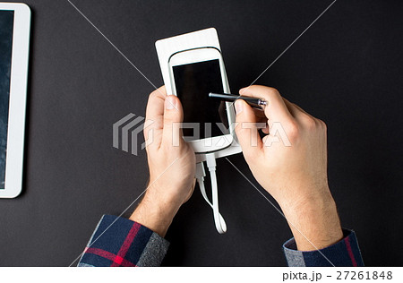 male hands holding a white cellphone male hands holding a white cellphone 27261848
