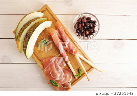 melon slices and bacon on bread sticks with olives melon slices and bacon on bread sticks with olives 27261948