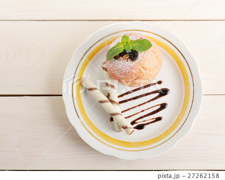 baked Apple with wafer rolls on a plate baked Apple with wafer rolls on a plate 27262158