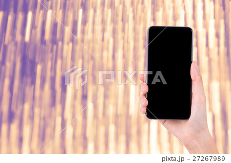 hand with mobile phone on bright background 27267989
