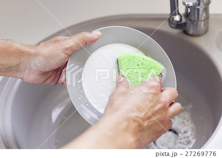 young man washing dishes young man washing dishes 27269776