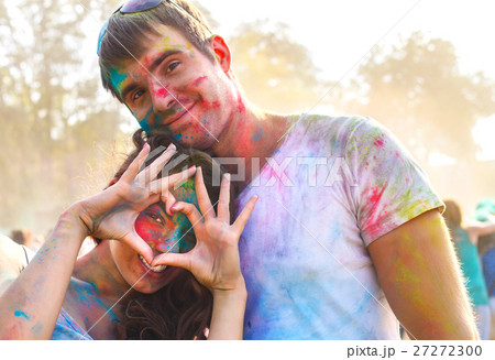Happy couple in love on holi color festival 27272300