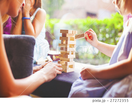 Mother and children playing wooden blocks tower 27272355