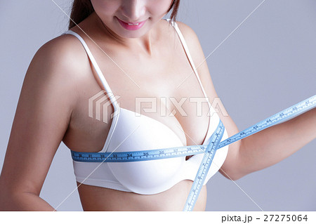 young woman checking breast measurement 27275064