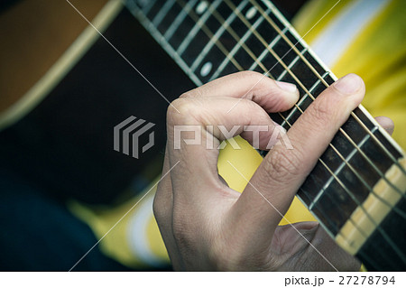 closeup of man's hands playing acoustic guitar closeup of man's hands playing acoustic guitar 27278794