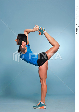 Athletic young woman doing stretching exercises Athletic young woman doing stretching exercises 27282756